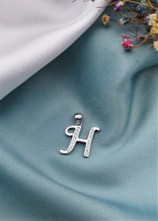 Dije letra H con circón rodinada
